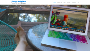 Live Work and Play Website Home Page with Sharyn McCullum sitting by her pool with her laptop.