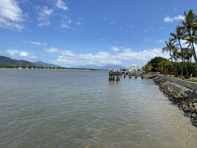 Cairns Foreshore. Boats Line The Cairns Foreshore With Mountains Behind.