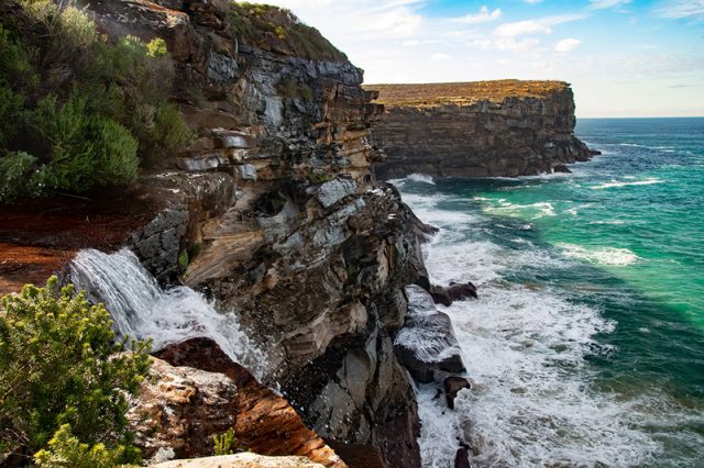 Royal National Park In Sydney Has A Coastal Track Along The Sheer Cliff Face. See Ocean Lapping The Cliffs As You Walk.