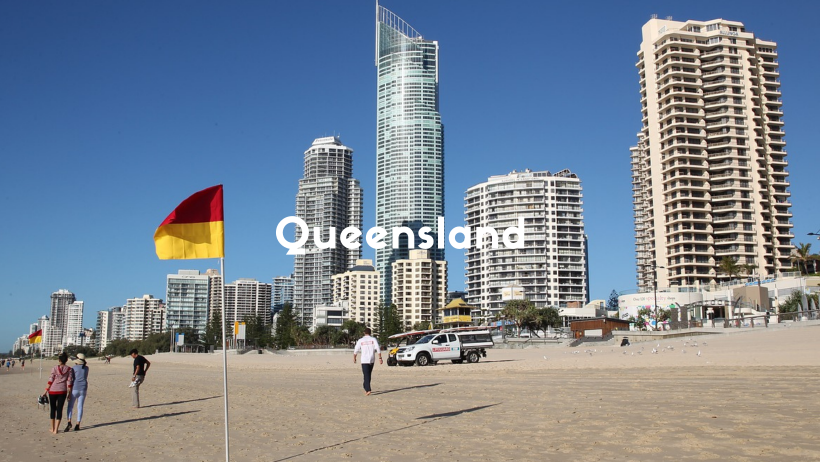 Golden Sandy Beach With Tall Buildings Along The Edge Of The Sand On The Gold Coast, Queensland.