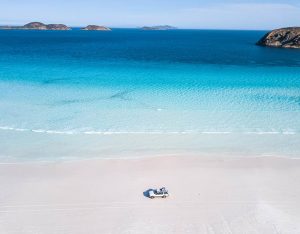 White Sand Beach With Aqua Water Lapping Her Shores.