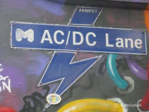 AC/DC Lane sign with street art.