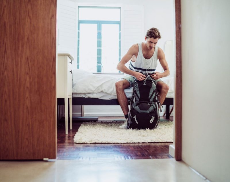 AussieBackpacker Male solo backpacker in his bedroom on a Australia working holiday day.