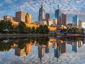 Melbourne city tall buildings reflecting in the Yarra River.