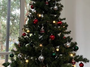My Christmas Tree. Green fake tree with gold and silver balls.