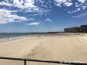 white sand lapped by small waves at Glenelg Beach.