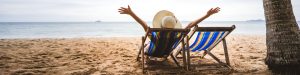 Person sitting on a deck chair at the beach is a great outdoor Australian activity.