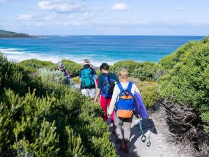 A group of people on a coastal hike in Australia.