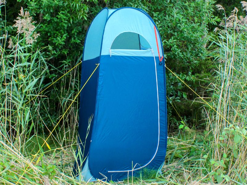 camping pop up shower tent toilet tent in the greenery.