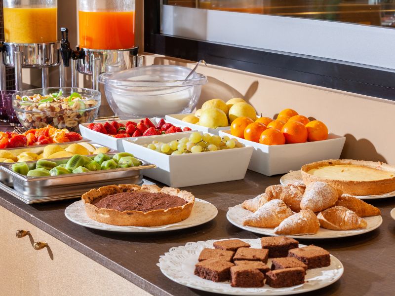 buffet style food - fruit, juices and other breakfast foods